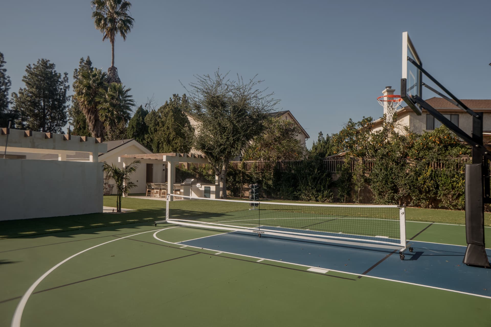 Private sports court beside a Los Angeles residence at golden hour